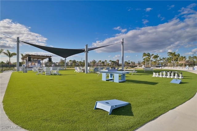 view of community featuring a yard and a pergola