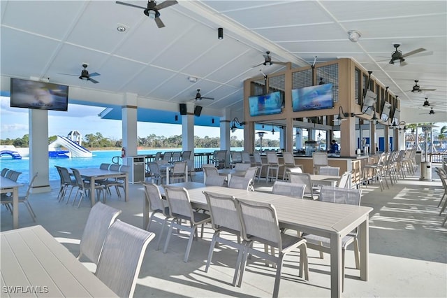 view of patio featuring ceiling fan and a community pool