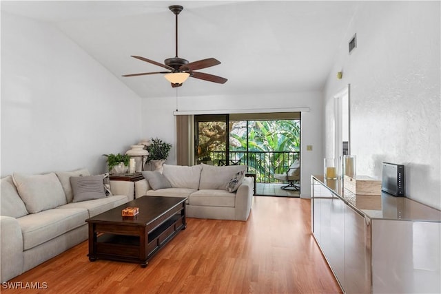 living room with lofted ceiling, light hardwood / wood-style floors, and ceiling fan