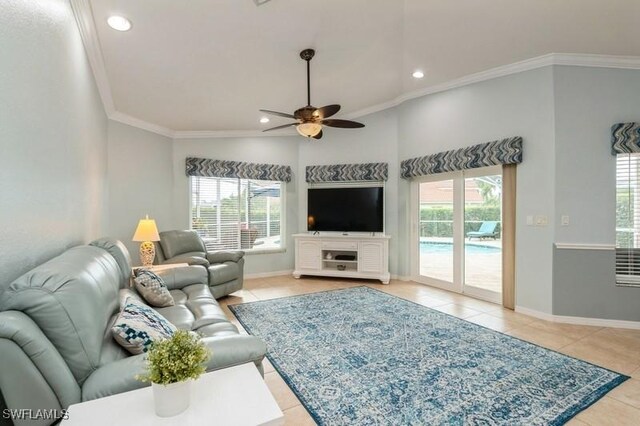 living room with light tile patterned floors, ceiling fan, baseboards, and crown molding