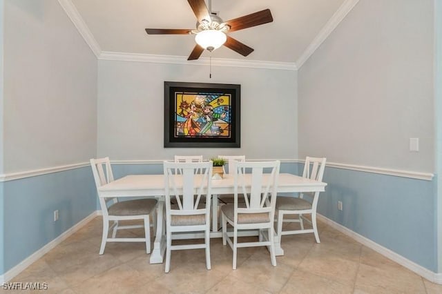 dining space featuring baseboards, ornamental molding, ceiling fan, and light tile patterned flooring