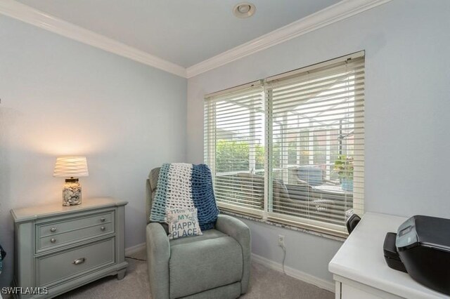 living area with light carpet, baseboards, and crown molding