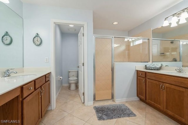 full bath with a sink, a shower stall, and toilet