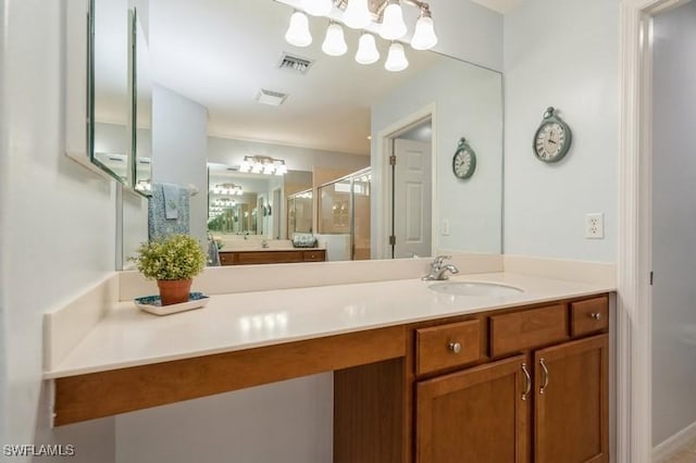 full bathroom with a stall shower, vanity, and visible vents