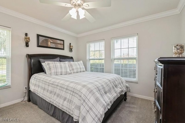 carpeted bedroom featuring ceiling fan, baseboards, and ornamental molding