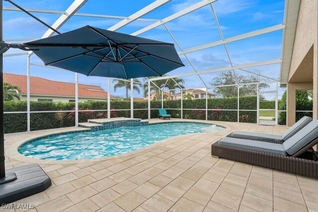 view of pool featuring a lanai, a patio area, and a fenced in pool