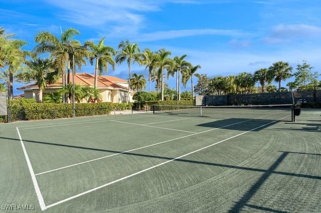 view of tennis court featuring fence