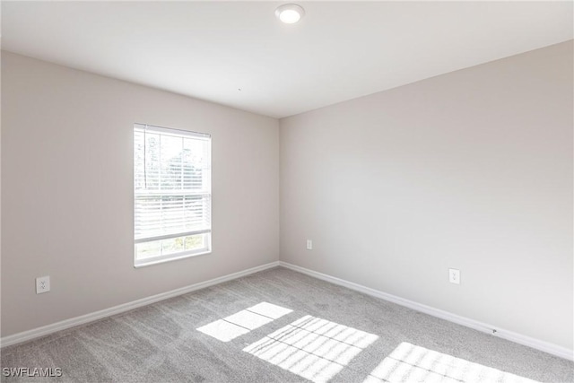 unfurnished room with light colored carpet