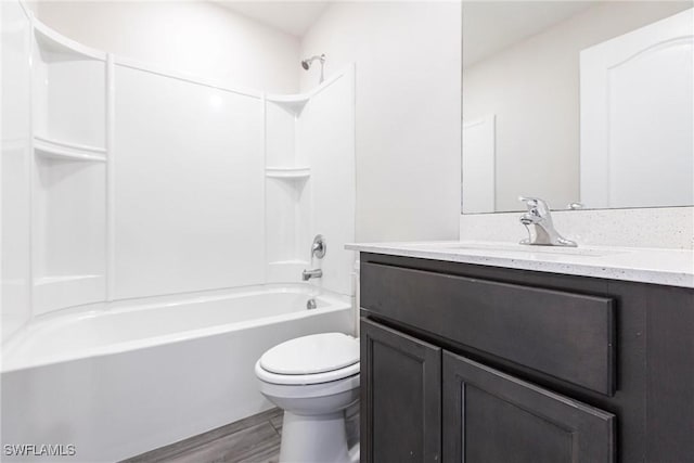 full bathroom featuring vanity, hardwood / wood-style floors, toilet, and shower / bath combination