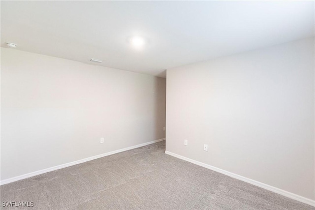 unfurnished room featuring light colored carpet