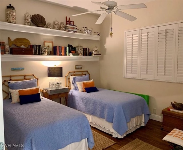 bedroom with ceiling fan and dark wood-type flooring