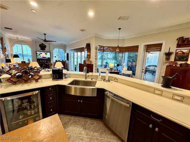 kitchen featuring sink, beverage cooler, dishwasher, hanging light fixtures, and ornamental molding