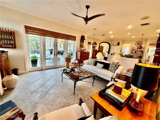 living room with ceiling fan, french doors, crown molding, and light tile patterned floors