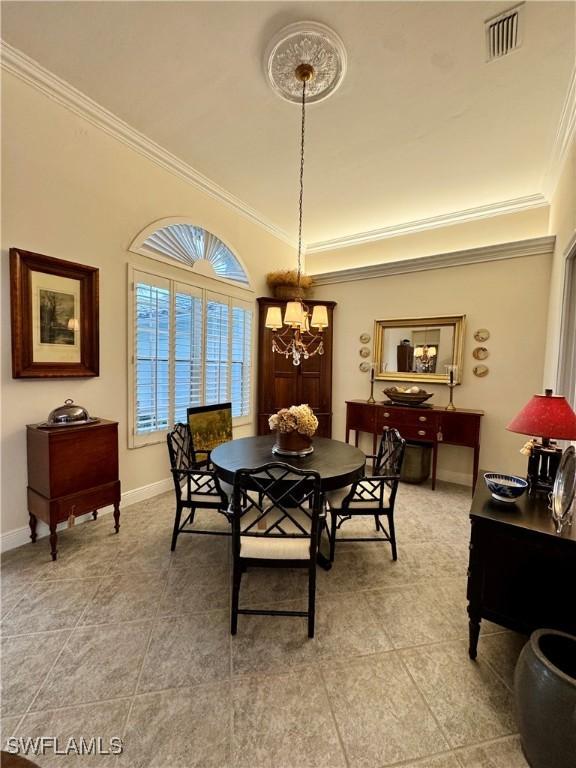 dining space with ornamental molding