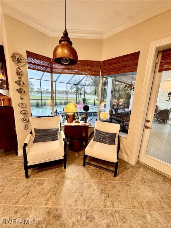 living area with a water view, ornamental molding, and tile patterned flooring