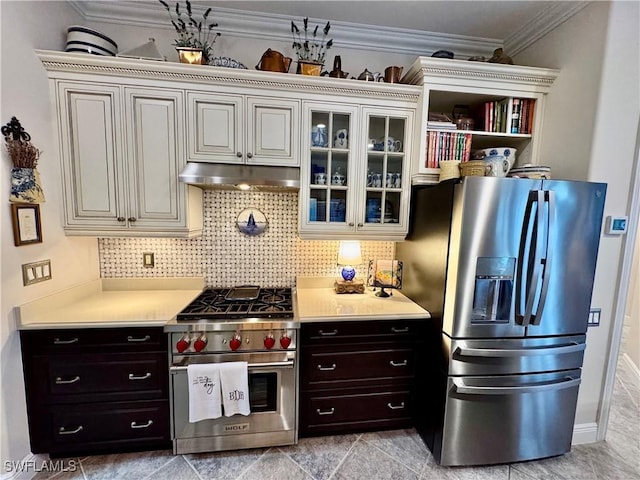 kitchen with ornamental molding, appliances with stainless steel finishes, dark brown cabinets, and backsplash