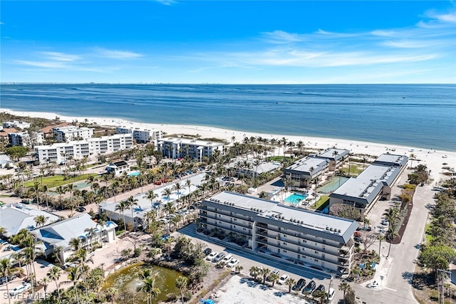 aerial view with a water view and a beach view