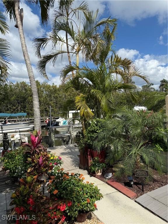 view of home's community with a water view and a boat dock