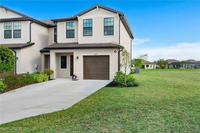 view of front of house featuring a garage and a front lawn