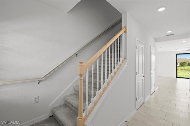 stairs with tile patterned floors