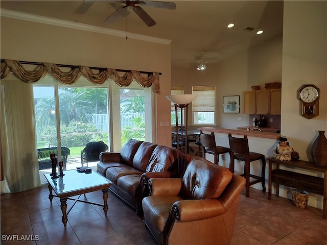 living area with visible vents, crown molding, dark tile patterned floors, and ceiling fan