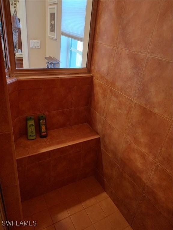 bathroom with a tile shower