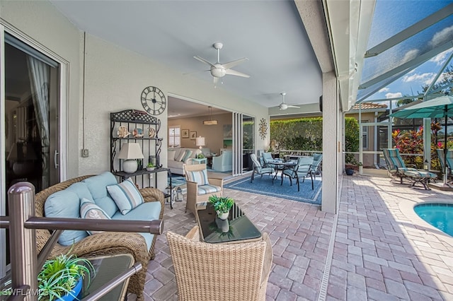 view of patio / terrace featuring a lanai, outdoor lounge area, and ceiling fan