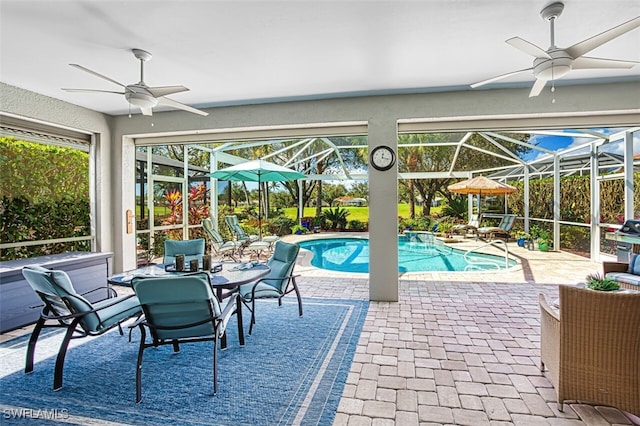 view of pool with a lanai, a patio, and ceiling fan