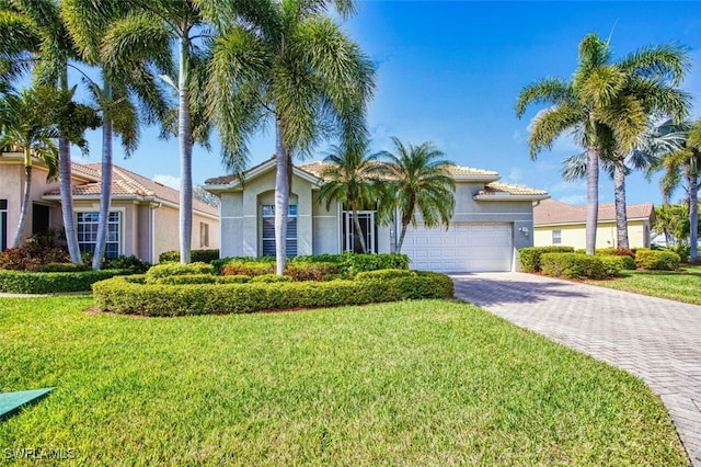 view of front of property with a garage and a front lawn