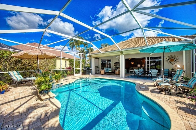 view of swimming pool with a lanai, grilling area, and a patio area