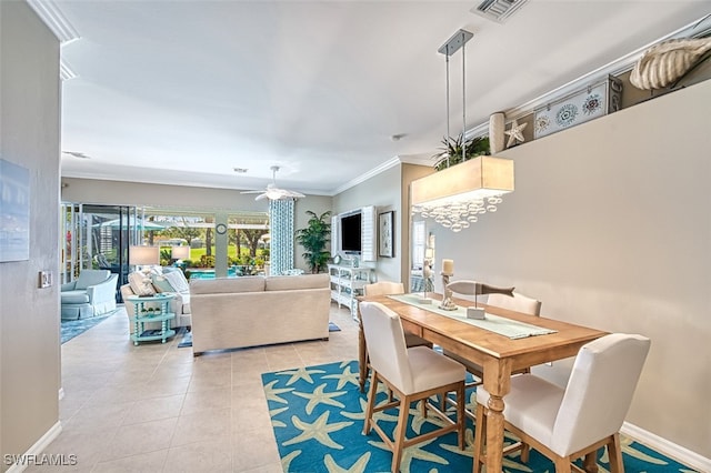 tiled dining space with crown molding and ceiling fan