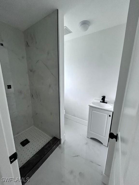 bathroom featuring vanity and a tile shower