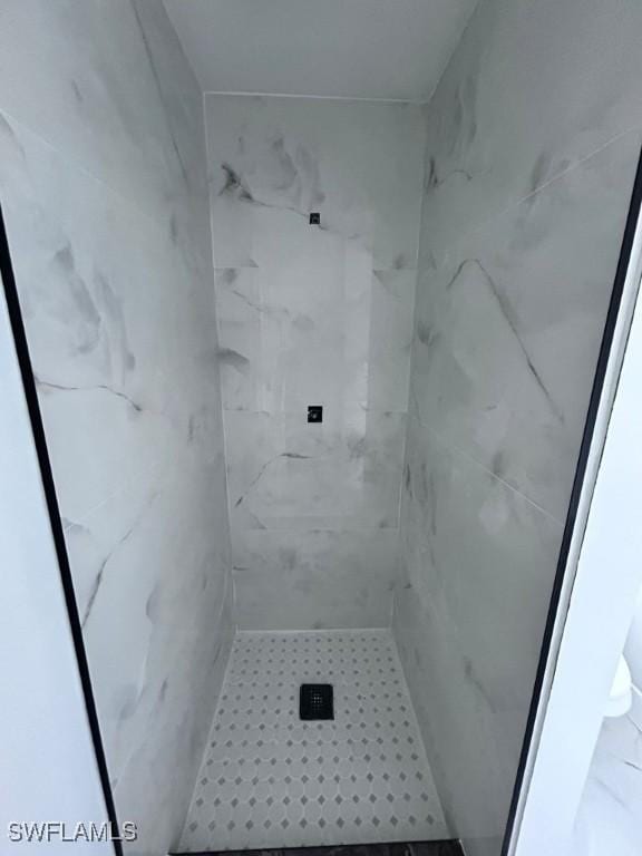 bathroom with tiled shower