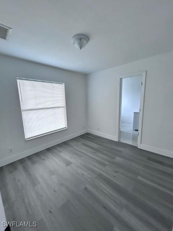 empty room featuring dark wood-type flooring