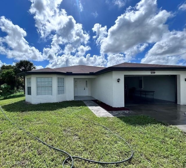 view of front of property featuring a garage and a front lawn