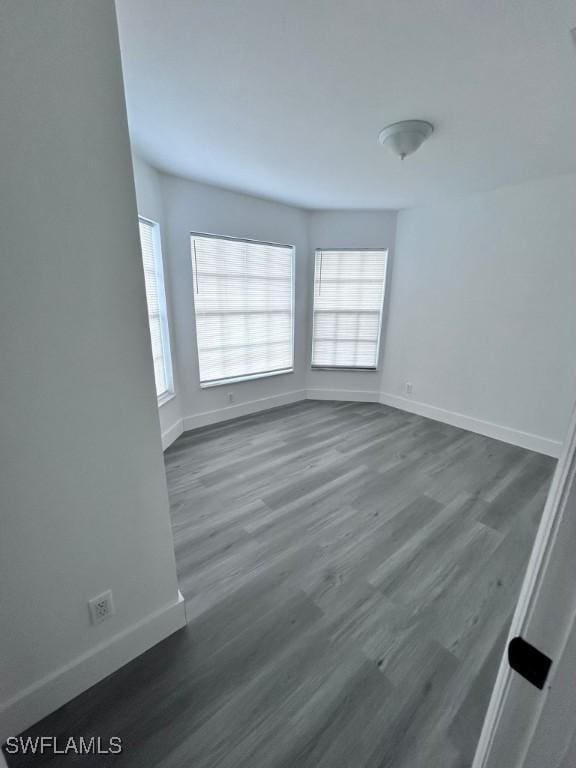 unfurnished room featuring dark wood-type flooring