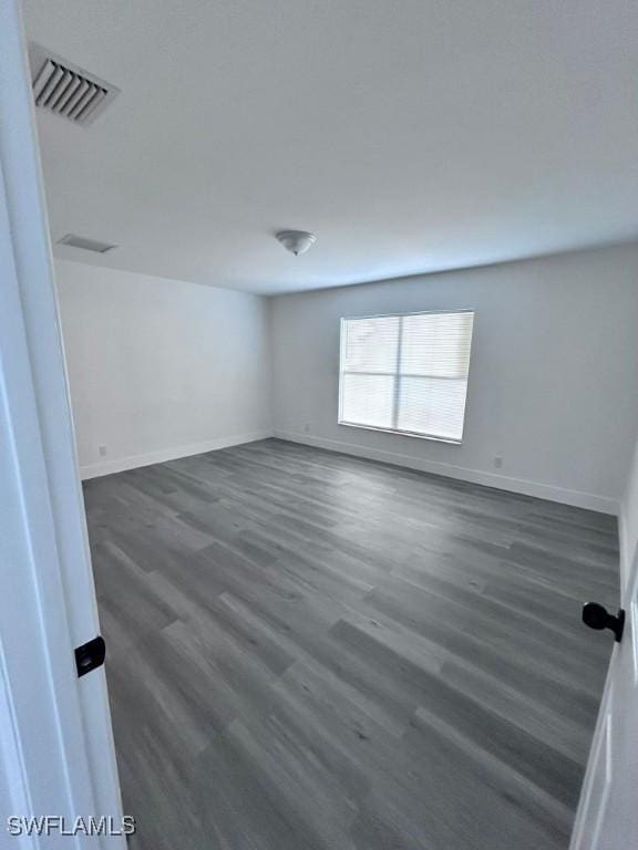 empty room featuring dark hardwood / wood-style flooring