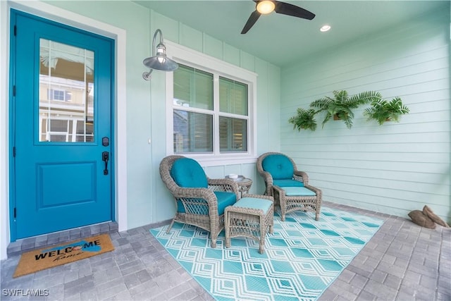 entrance to property featuring ceiling fan and covered porch