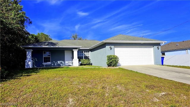 ranch-style house featuring a garage and a front lawn