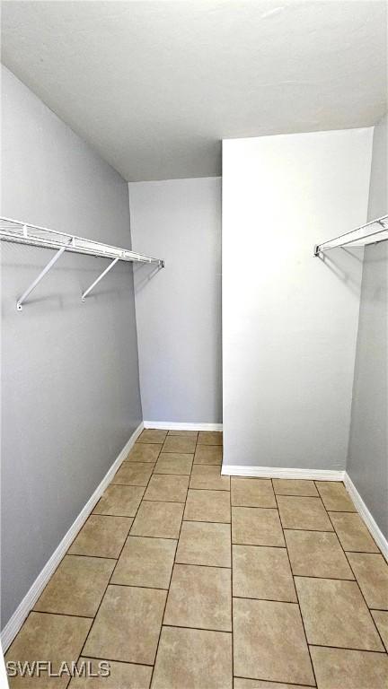 walk in closet featuring tile patterned flooring