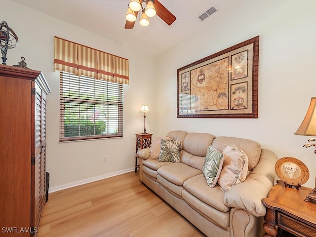 living room featuring ceiling fan and light hardwood / wood-style flooring