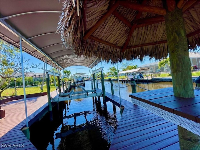 dock area with a water view and boat lift