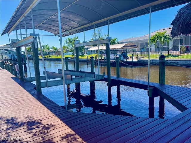 dock area with a water view and boat lift