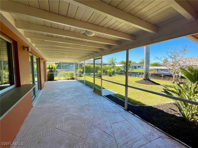 exterior space featuring beam ceiling, wooden ceiling, and a wealth of natural light