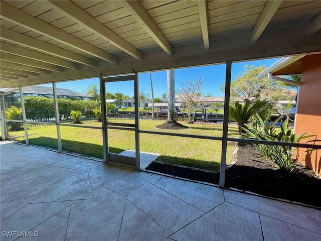 unfurnished sunroom with beamed ceiling