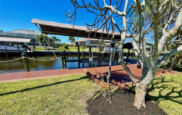 dock area featuring a water view, boat lift, and a lawn