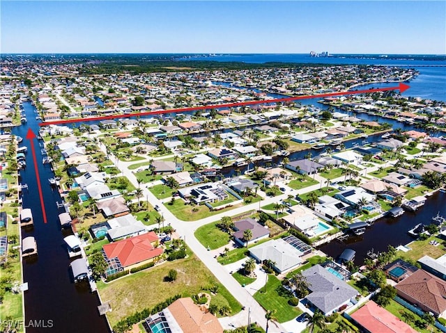 birds eye view of property with a water view and a residential view