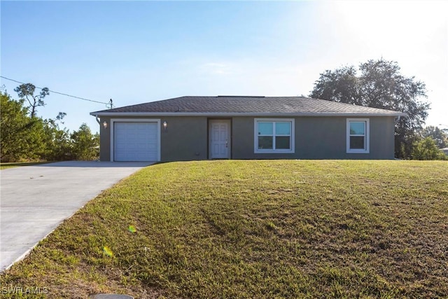 single story home with a garage and a front lawn