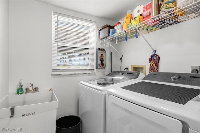 laundry room featuring separate washer and dryer and sink