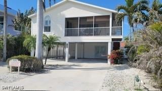 view of front of property with a carport and concrete driveway